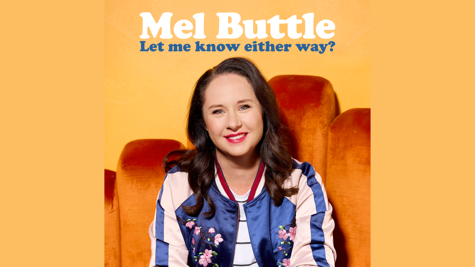 Image of Mel Buttle sitting on orange velvet chair